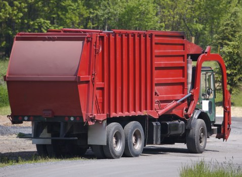 Staff sorting recyclables into labelled containers at a commercial site